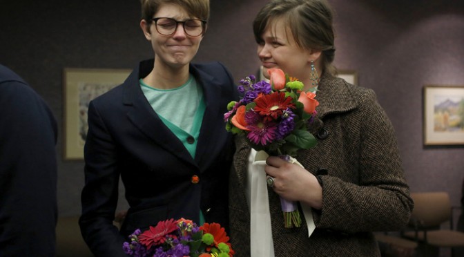 Natalie Dicou, left, and her partner Nicole Christensen wait to get married at the Salt Lake County Clerks office in Salt Lake  City, Utah, December 20, 2013. A U.S. federal judge struck down Utah's ban on same-sex marriage on December 20, 2013 in a ruling that found the prohibition violated the U.S. Constitution, potentially clearing the way for the state to become the 18th in the nation to allow gay marriage. REUTERS/Jim Urquhart